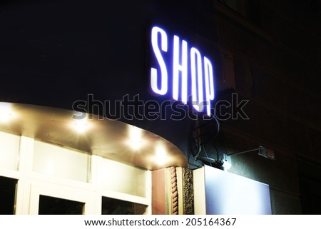 Neon sign on store at night