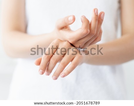 Hand skincare. Moisturizing cosmetology. Skin protection. Closeup of woman gentle palms smearing soothing cream product at white background. Royalty-Free Stock Photo #2051678789