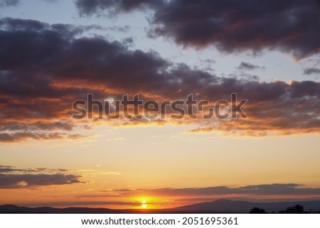 yellow and orange clouds at sunset. dramatic sky skyline background                    