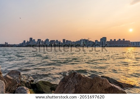 View of downtown Montreal city skyline and Saint Lawrence River at sunset, Quebec, Canada.