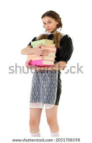 Happy pretty girl holding pile of heavy books