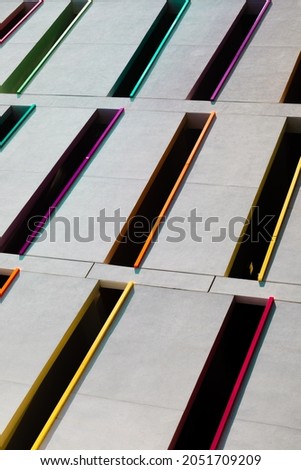 Rectangle pattern with colors. Daylight. Building parking lot