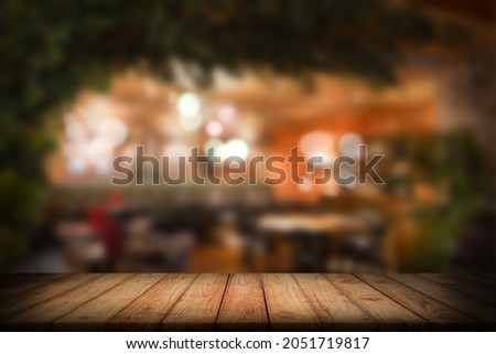 Blurred background of a bar. Wooden worktop in foreground Royalty-Free Stock Photo #2051719817