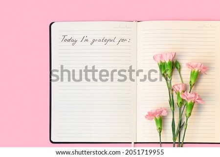 Top view of flowers on open paper notebook with handwritten words Today I'm grateful for. Gratitude journal concept Royalty-Free Stock Photo #2051719955