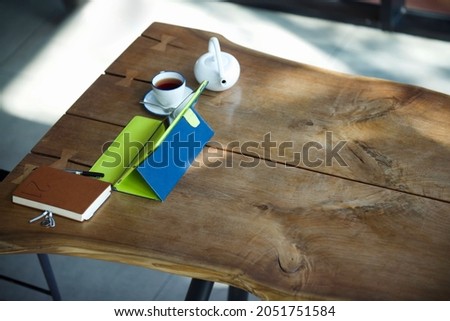 Workspace with notebook, note book, tea and teacup.Working place for professional. Online work with wifi.
