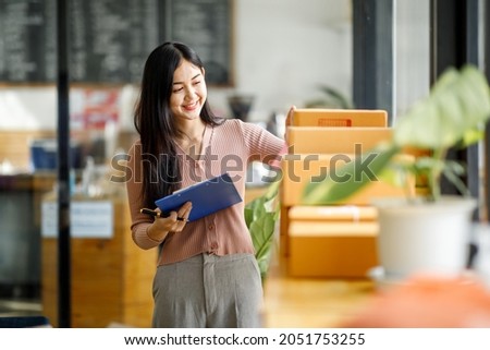 Portrait of Starting small businesses owners female entrepreneurs working on receipt box and check online orders to prepare to pack the boxes, sell to customers, sme business ideas online. Royalty-Free Stock Photo #2051753255