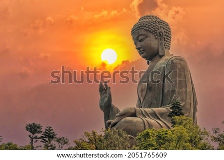Big bronze Amoghasiddhi Buddha statue called Tian Tan Buddha with sunset sky at Po Lin Monastery Ngong Ping in Lantau Island famous tourist destination in Hong Kong China Royalty-Free Stock Photo #2051765609