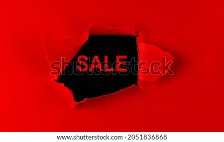 Red Torn paper with a word Sale on black background