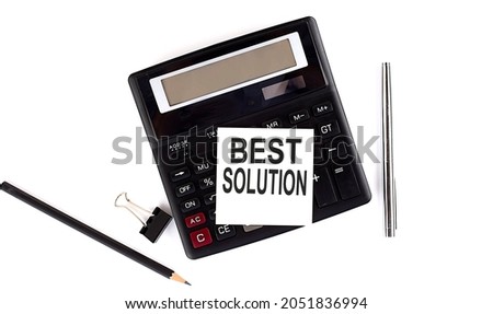 BEST SOLUTION text on sticker on calculator with pen,pencil on the white background