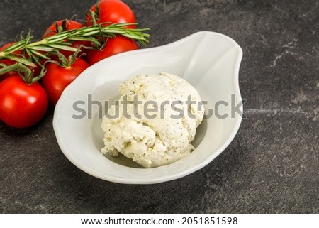 Soft cream cheese with herbs in the bowl