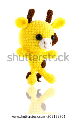 handmade crochet yellow giraffe doll on white background, right side