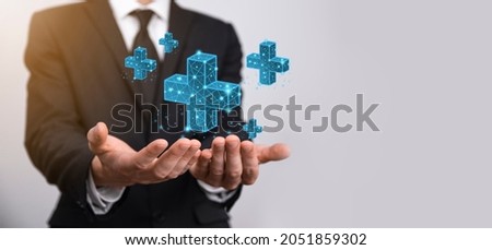 Businessman hand holding 3D plus low polygonal icon.Plus sign virtual means to offer positive thing like benefits, personal development, social network Profit,health insurance, growth concepts Royalty-Free Stock Photo #2051859302