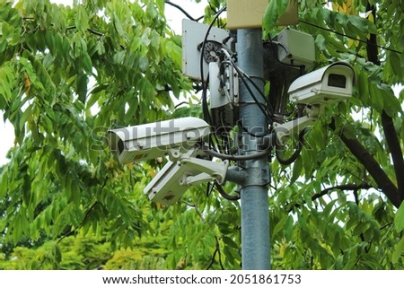 CCTV in the park mounted on a rod in high angle.  Can look around to make people safe for the surrounding people.