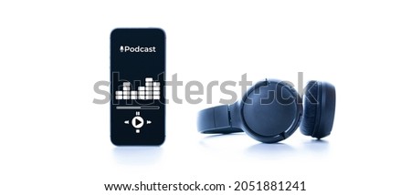 Podcast background. Mobile smartphone screen with podcast application, sound headphones. Audio voice with radio microphone on white. Recording studio or podcasting banner with copy space Royalty-Free Stock Photo #2051881241