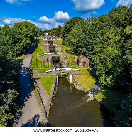 An aerial view above the Five Locks on the Leeds, Liverpool canal at Bingley, Yorkshire, UK in summertime