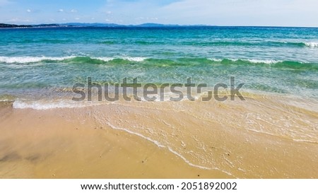 sea, sandy sea beach on a bright sunny day. Sand with blurred tropical sandy beach bokeh background, Summer vacation and product advertisement concept