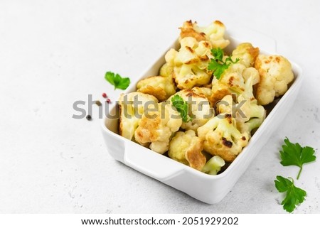 Vegan beer battered cauliflower in baking dish. Space for text. Royalty-Free Stock Photo #2051929202