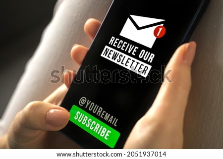 Woman holding mobile phone with newsletter signup page close-up. Register a new member concept photo closeup. Subscribe button