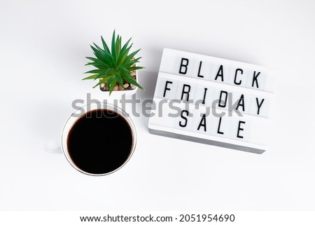 Black Friday concept. Cup of coffee and lightbox on white background. Sale and discounts.