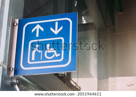 Blue sign of public elevator or lift for disabled person, handicap and wheel chair people in the building.