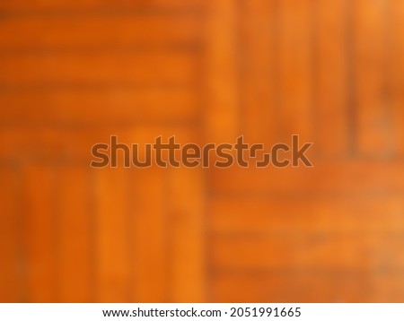 blur background of four brown square old planks with horizontal and vertical stripes arranged alternately use as backdrop