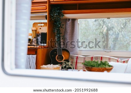 cozy kitchen interior in the trailer of mobile home or recreational vehicle, concept of family local travel in native country on caravan or camper van and camping life Royalty-Free Stock Photo #2051992688