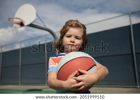 Kid playing basketball. Child boy preparing for basketball shooting. Active lifestyle. Basketball kids school.