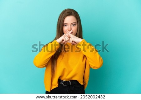 Teenager girl over isolated blue background showing a sign of silence gesture