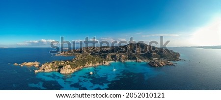 View from above, aerial shot, stunning panoramic view of Spargi Island with Cala Corsara, a white sand beach bathed by a turquoise water. La Maddalena archipelago National Park, Sardinia, Italy. Royalty-Free Stock Photo #2052010121