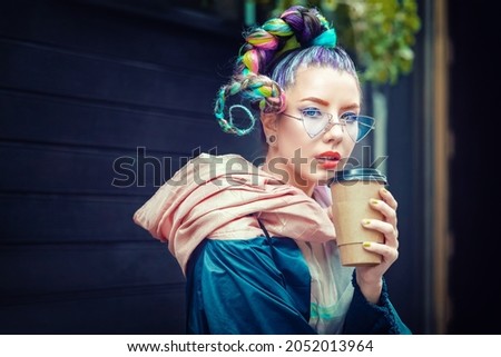Cool funky young girl with piercing and crazy hair enjoy takeaway coffee on street – Hipster woman with trendy colorful avant-garde look and modern sunglasses having fun outdoor Royalty-Free Stock Photo #2052013964