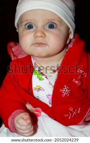 Funny infant baby girl with different emotional face expressions on dark background