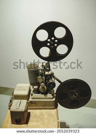 Old style movie projector, still-life, close-up. vintage, old-fashioned film projector, blurred background, photo