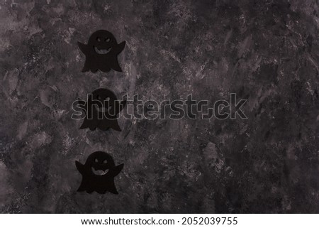 Three Halloween black ghosts shape stickers on grey background. Halloween frame card, copy space