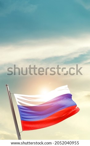 Russia national flag waving in beautiful clouds.