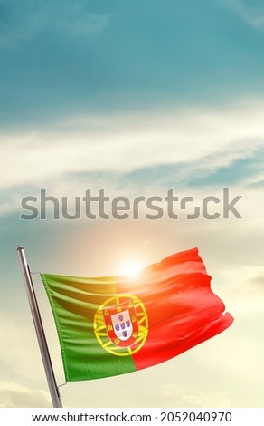 Portugal national flag waving in beautiful clouds.