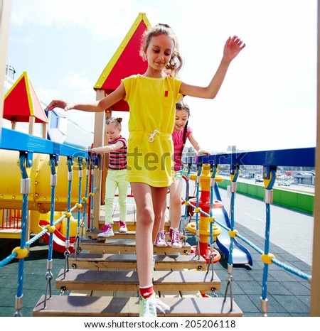 Image of cute girls having fun on playground outdoors 