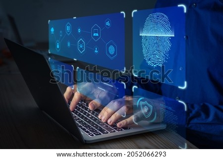 Fingerprint scan for secure access to protected data network with biometrics. Person using finger print authentication technology on laptop computer to login on private system.