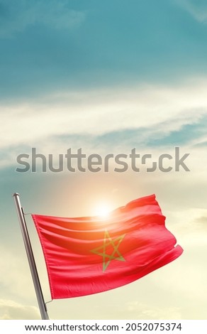 Morocco national flag waving in beautiful clouds.