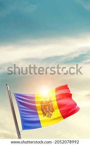 Moldova national flag waving in beautiful clouds.