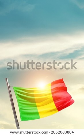 Mali national flag waving in beautiful clouds.