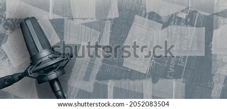 Storytelling audio podcast banner background with copy space. Microphone on book pages wall background. Story series podcasting. Royalty-Free Stock Photo #2052083504