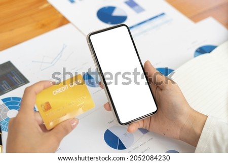 Top view Mockup image hand using a smartphone man Holding Cell Phone With Blank Screen