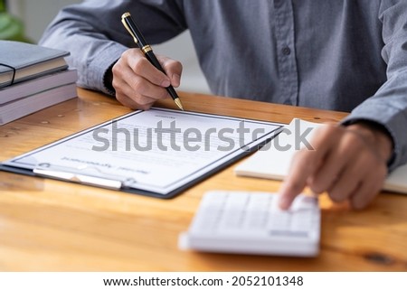 man hand signing a contract, Salesmen are letting the male customers sign the sales contract, Asian men doing business in the office, Business concept and contract signing
