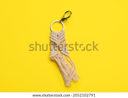 Handmade cotton keychain on color background