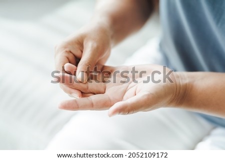 Woman suffering from hand and finger joint pain​.​ Causes of rheumatoid arthritis, carpal tunnel syndrome, gout. Health care and medical concept. Royalty-Free Stock Photo #2052109172