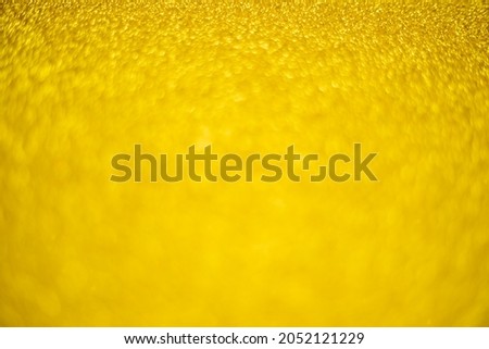 Blurry shimmering background of gold-colored sequins. Silver glitter, light abstract bokeh texture. Drawing design. Sparkling wallpaper for Christmas. Party time.
