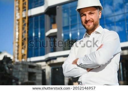 A construction worker control in the construction of roof structures on construction site and sunset background
