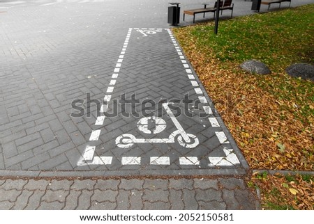 city and traffic - marking of scooter parking spot on street in autumn