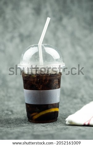 Cool ice soft drink in plastic glass