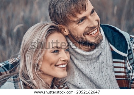 Beautiful young loving couple bonding and smiling while spending time outdoors Royalty-Free Stock Photo #2052162647